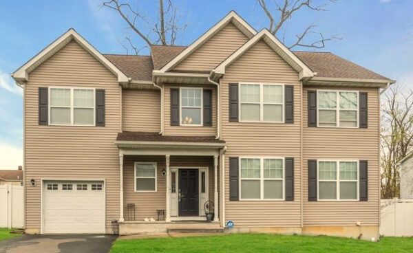 Two-story house representing multiple properties insurance coverage