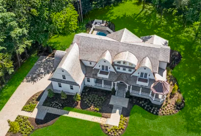 Brick Georgian residence in Rumson showing mature trees and manicured lawn