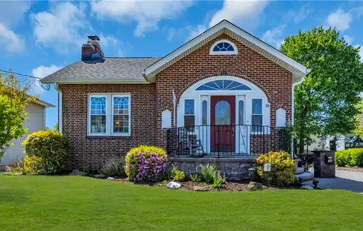 Two‑story colonial in Edison with a manicured lawn and attached garage