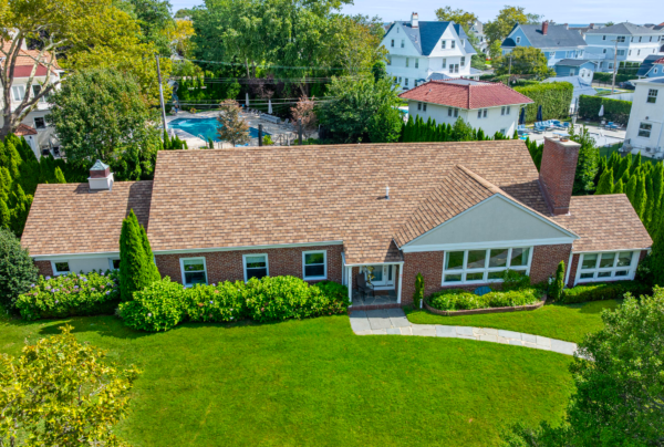 Historic Allenhurst Victorian with ornate trim and manicured landscaping