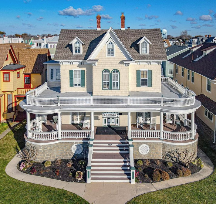Two‑story Cape May seaside home with turret and manicured lawn