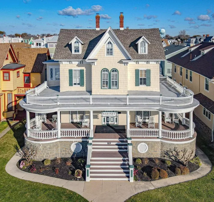 Two‑story Cape May seaside home with turret and manicured lawn
