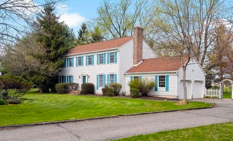 Colonial residence in Flemington with white trim and manicured front yard