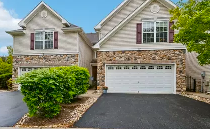 Pennington colonial home with brick facade and mature trees