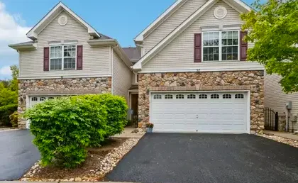 Pennington colonial home with brick facade and mature trees