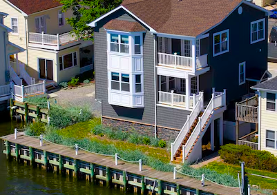 Sandy Hook cottage framed by maritime forest and sandy pathways