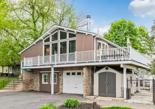 Wooded West Milford residence with detached garage and gravel driveway