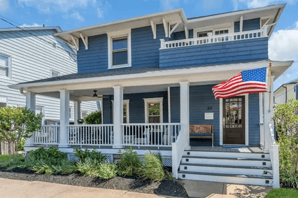 Avon-by-the-Sea Victorian home beside Fletcher Lake with wraparound porch and period woodwork
